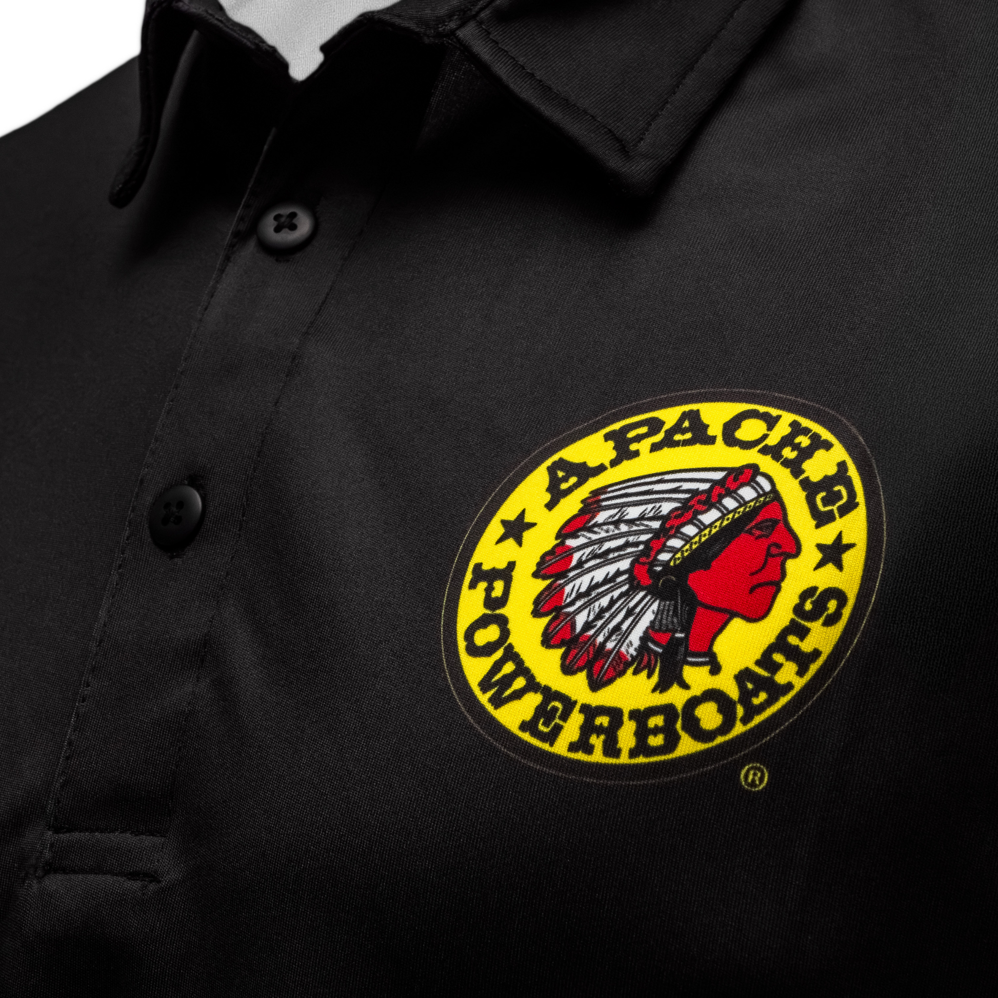 Detailed view of Apache warrior logo on front left chest of 40th Anniversary performance polo